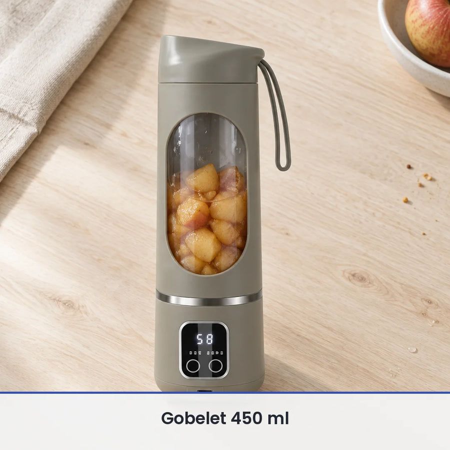 Blender portable vert sauge 450 ml rempli de morceaux de pommes cuites, sur un plan de travail en bois clair