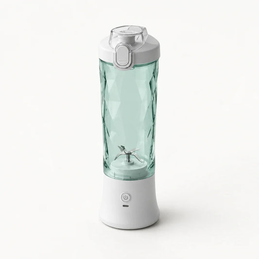 Blender portable 600 ml blanc avec gobelet vert d'eau à facettes et couvercle gris clair à clapet, sur fond blanc cassé