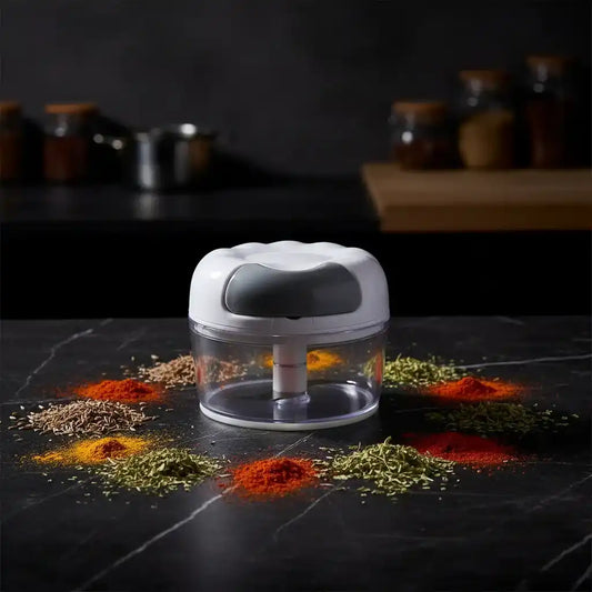 Hachoir manuel compact sur plan de travail en marbre noir avec épices colorées — graines de cumin et paprika — éclairage cinématographique dramatique