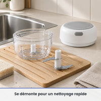 Bol transparent et couteau du mini hachoir électrique blanc lavés près d'un évier, couvercle-moteur posé au sec à côté