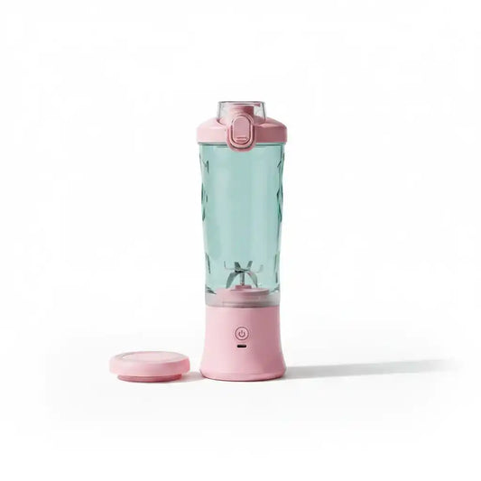 Mixeur portable rechargeable rose avec cuve transparente à facettes diamant, couvercle et base rose, sur fond blanc